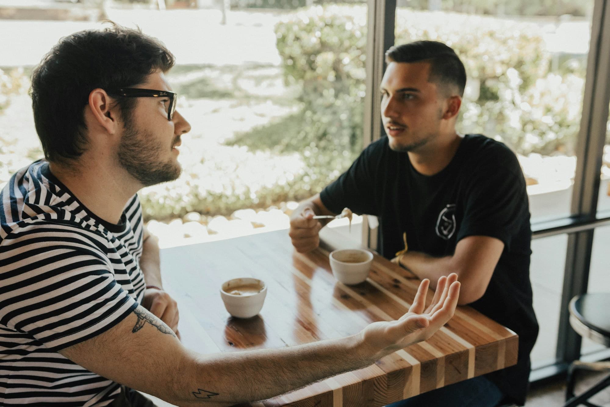 Two men in conversation across a table